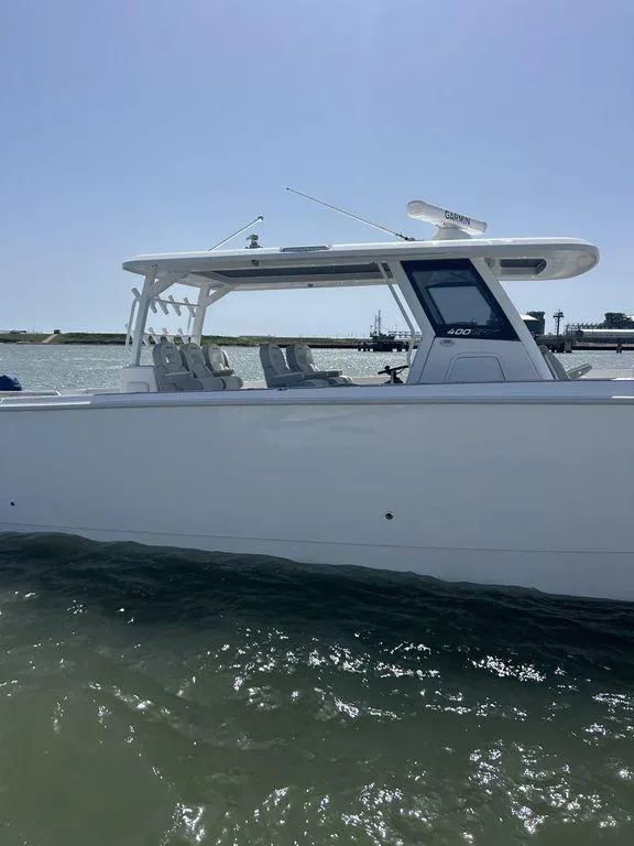 Slide: The Image of 2024 Twin Vee 400 GFX boat on water, side view, sunny day. - 5