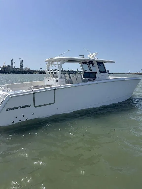 Slide: The Image of 2024 Twin Vee 400 GFX boat on water, showcasing sleek design and modern features. - 6