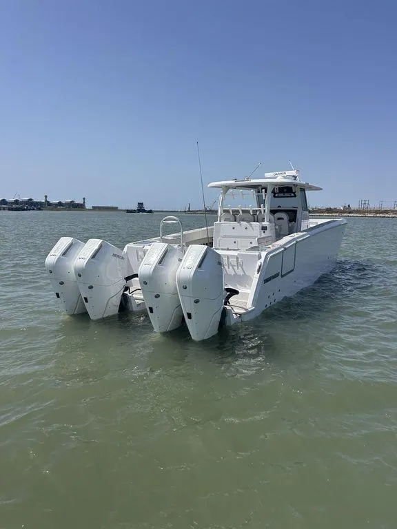 Slide: The Image of 2024 Twin Vee 400 GFX boat with triple engines on calm water. - 9