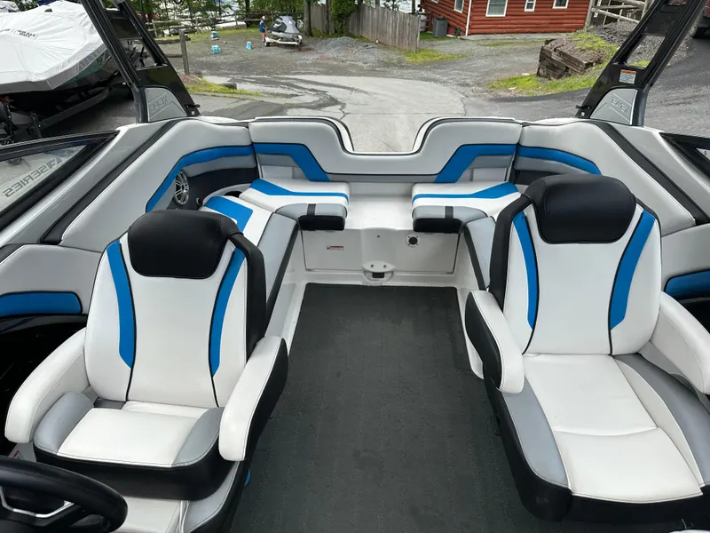 Slide: The Image of 2016 Yamaha Boats 242X E-Series interior with blue and white seating, showcasing modern design. - 18