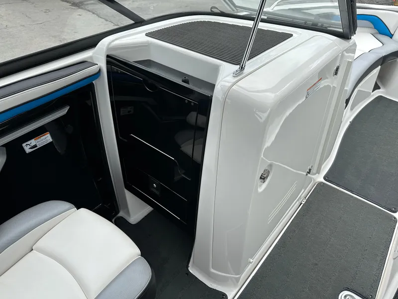 Slide: The Image of Interior view of a 2016 Yamaha Boats 242X E-Series, showcasing seating and storage. - 21