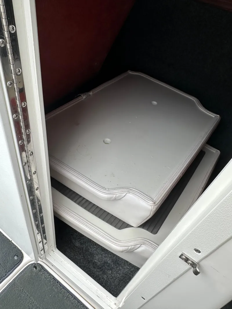 Slide: The Image of Storage compartment with cushions in a 2016 Yamaha Boats 242X E-Series. - 22