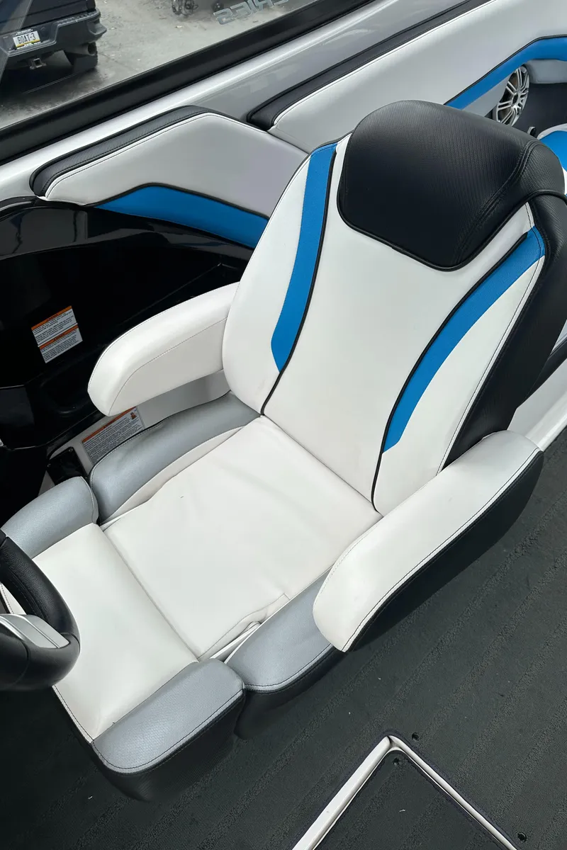 Slide: The Image of 2016 Yamaha Boats 242X E-Series seat with white, blue, and black design. - 28