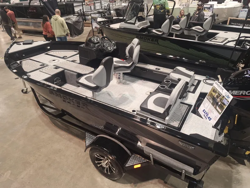 Slide: The Image of 2025 Smoker Craft Excursion 166 SC fishing boat on display in showroom. - 2