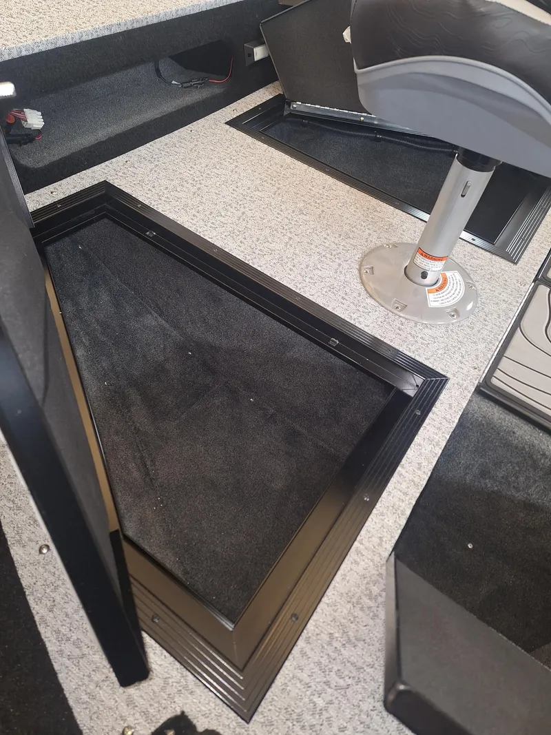 Slide: The Image of 2025 Smoker Craft Excursion 166 SC boat interior with storage compartments and seating. - 4