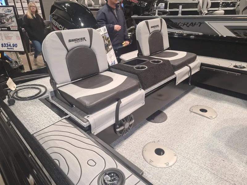 Slide: The Image of 2025 Smoker Craft Excursion 166 SC boat interior with seating and storage compartments. - 6