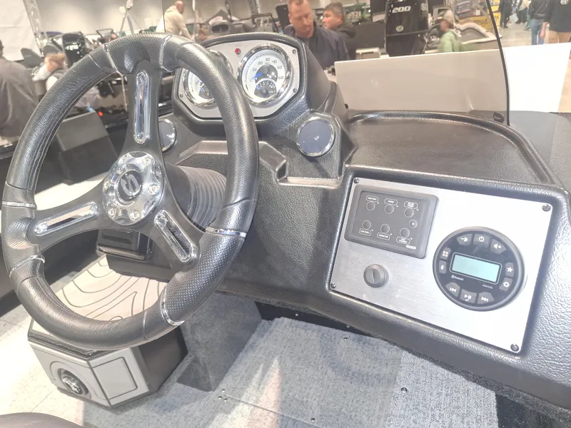 Slide: The Image of 2025 Smoker Craft Excursion 166 SC dashboard with steering wheel and control panel. - 7