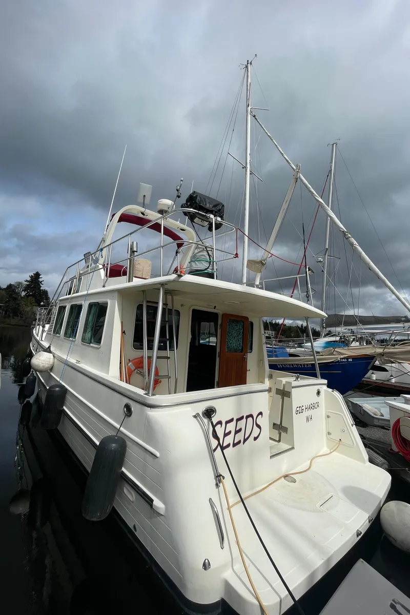 Slide: The Image of 2006 North Pacific 42 yacht docked, overcast sky, marina setting. - 1