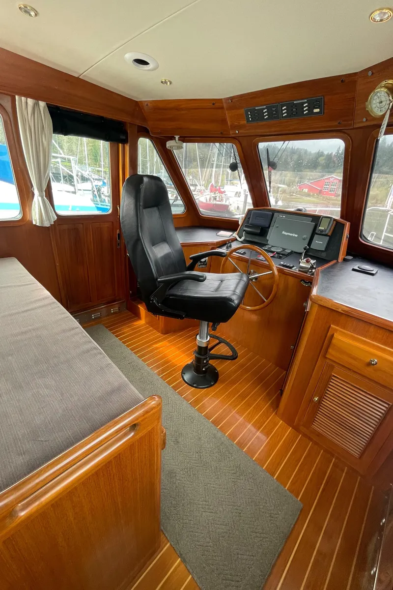Slide: The Image of Pilothouse interior of 2006 North Pacific 42 yacht with wooden finish and captain's chair. - 19