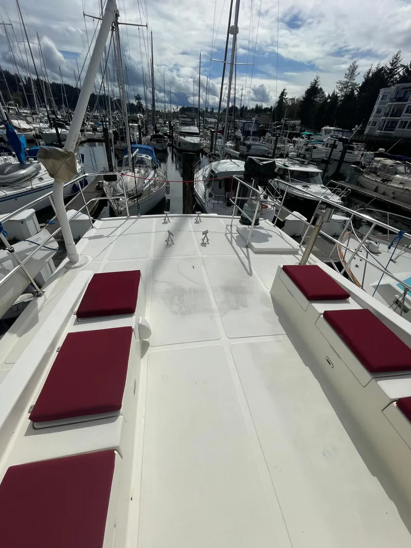 Slide: The Image of 2006 North Pacific 42 yacht with red cushions docked in a marina. - 24