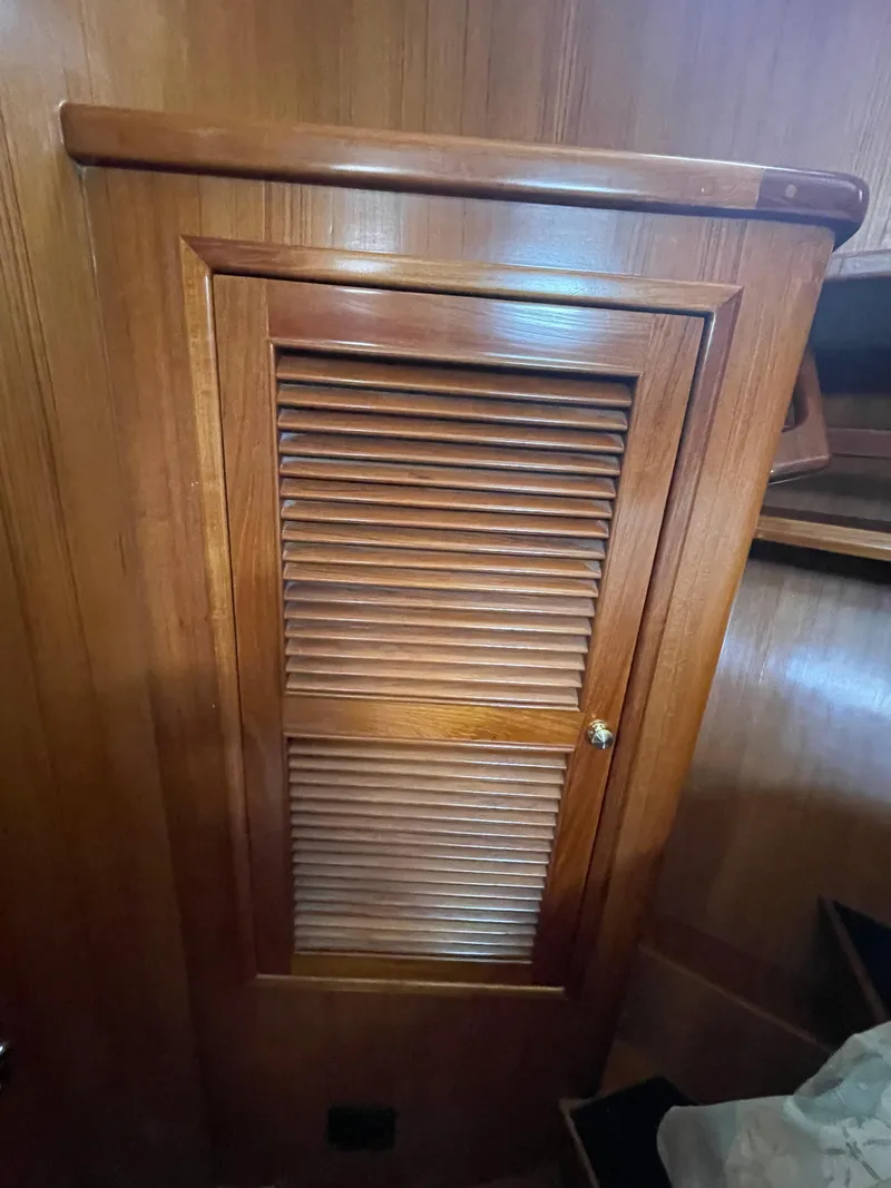 Slide: The Image of Wooden louvered cabinet door inside a 2006 North Pacific 42 boat. - 28