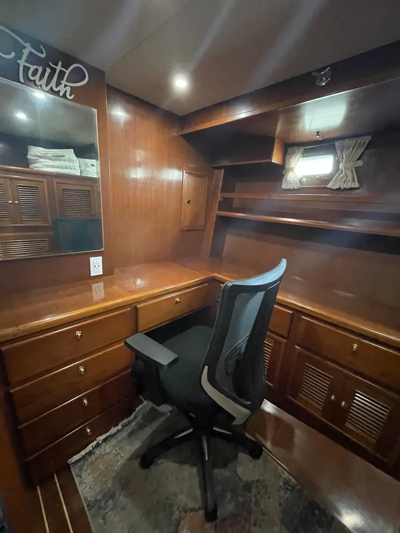 Slide: The Image of 2006 North Pacific 42 yacht interior with wooden desk, chair, and storage cabinets. - 30