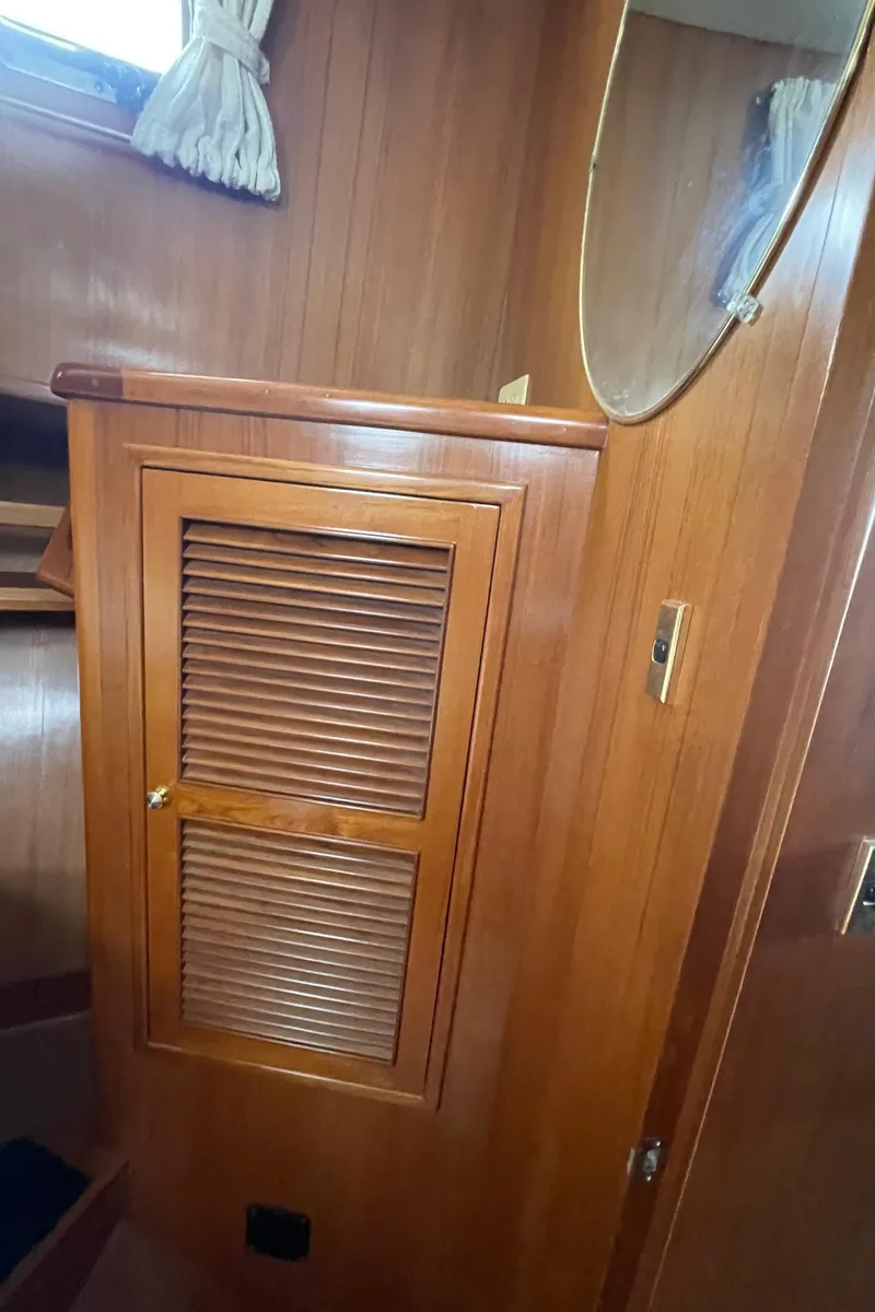 Slide: The Image of Wooden interior of 2006 North Pacific 42 boat with louvered cabinet. - 31