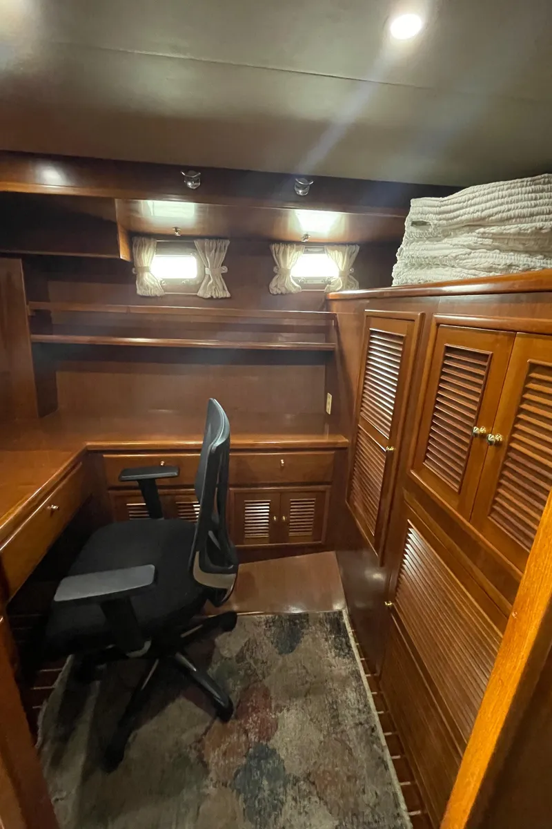 Slide: The Image of Interior of 2006 North Pacific 42 yacht with wooden cabinetry and office chair. - 32
