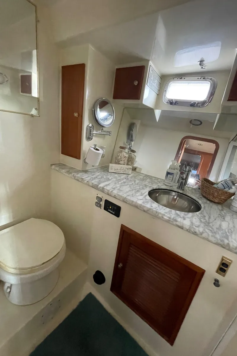 Slide: The Image of 2006 North Pacific 42 yacht bathroom with marble countertop and stainless steel sink. - 34