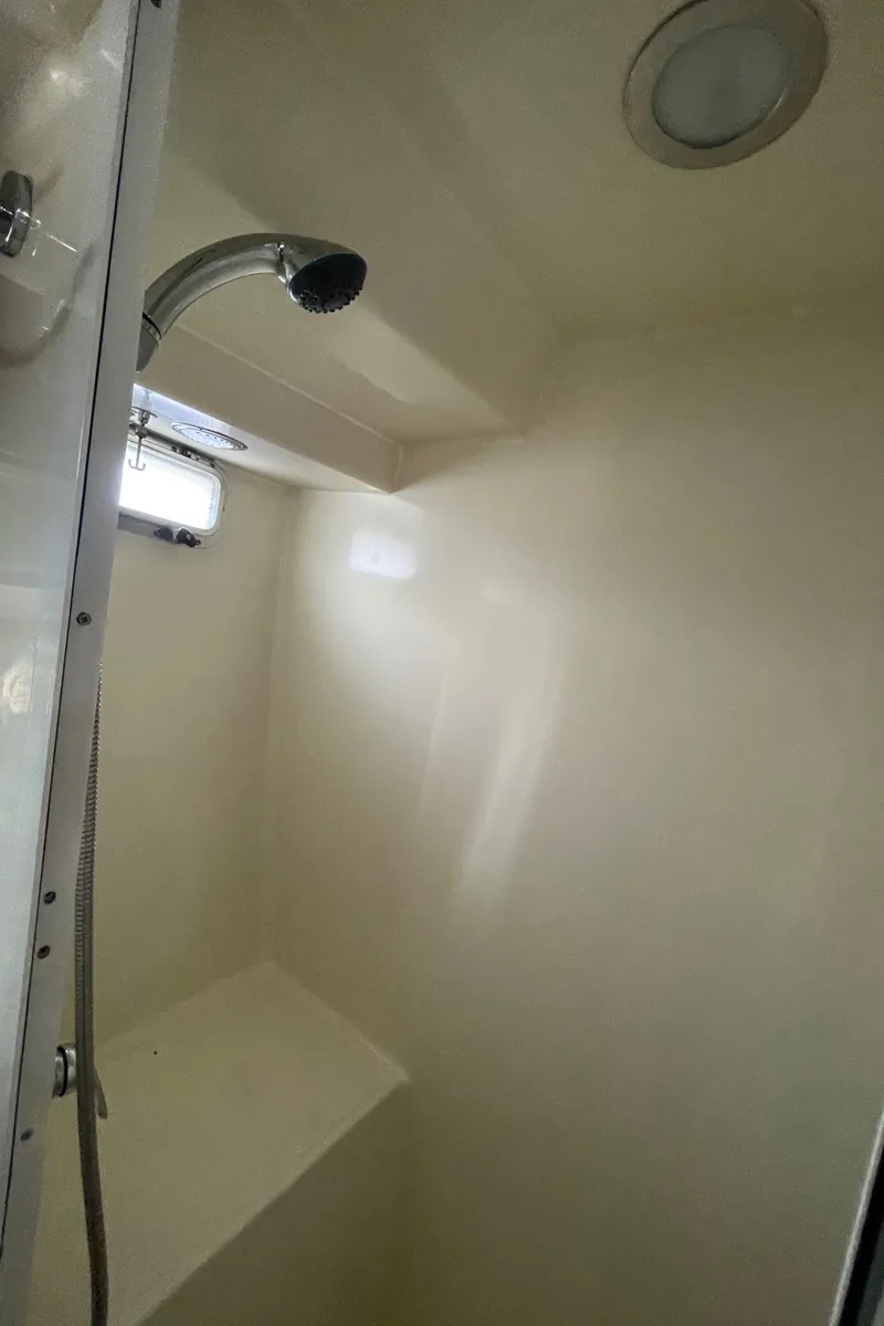 Slide: The Image of Shower area in 2006 North Pacific 42 yacht, featuring a modern design and overhead lighting. - 35