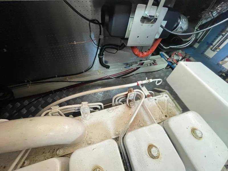 Slide: The Image of Engine room of a 2006 North Pacific 42 boat, showcasing mechanical components and wiring. - 39