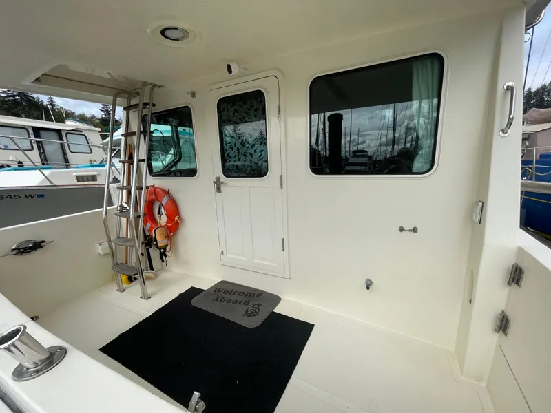 Slide: The Image of 2006 North Pacific 42 boat deck with ladder, door, and life preserver. - 4