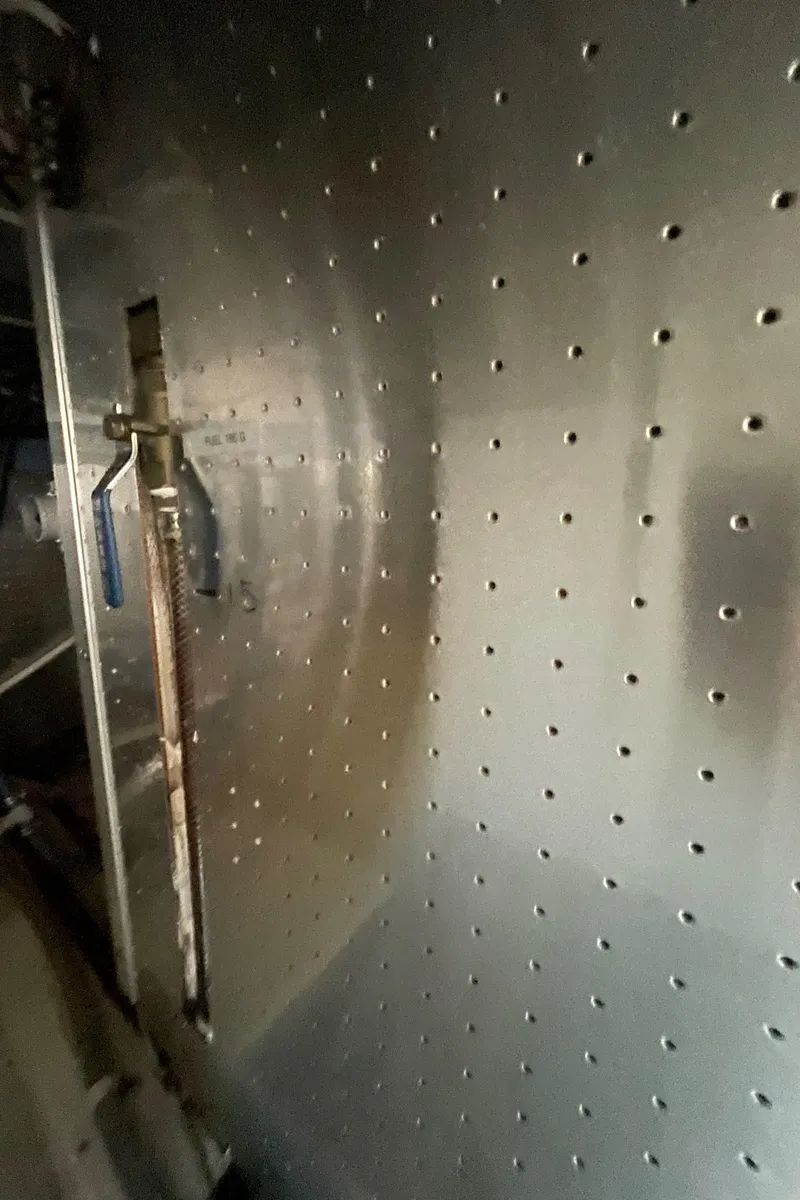 Slide: The Image of Interior view of a 2006 North Pacific 42 boat, featuring a perforated metal panel. - 46