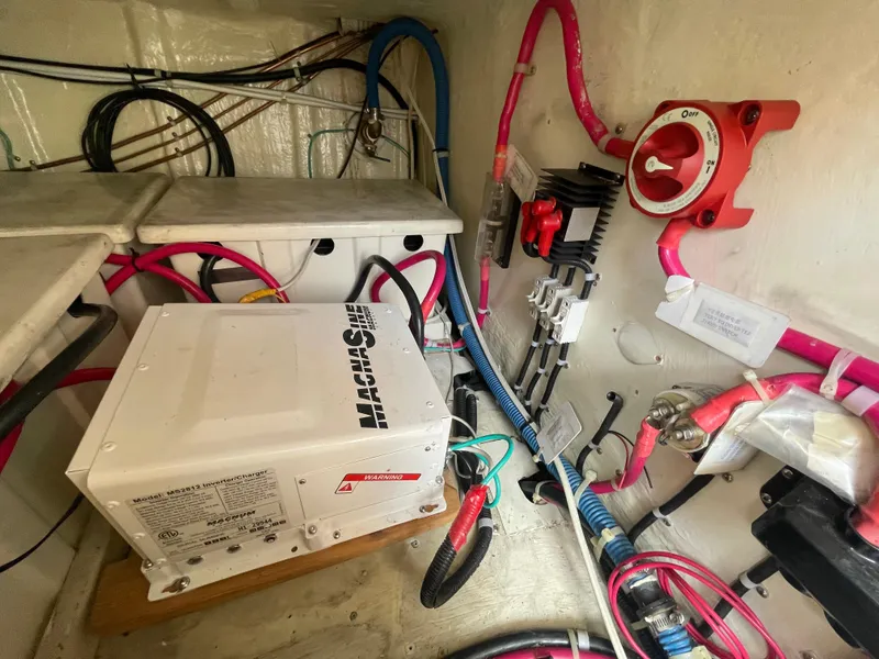 Slide: The Image of Electrical system inside a 2006 North Pacific 42 boat, featuring wiring and control panel. - 47