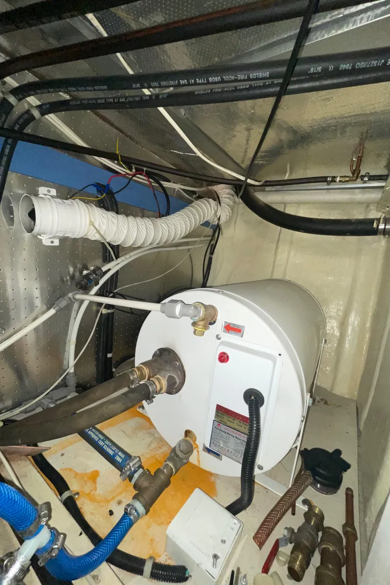 Slide: The Image of Engine room of a 2006 North Pacific 42 boat, featuring plumbing and equipment. - 49