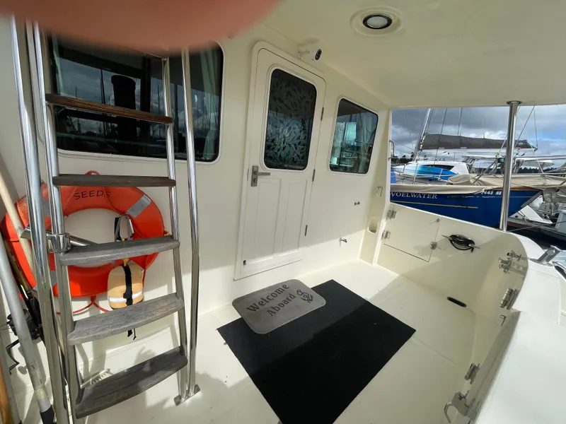 Slide: The Image of North Pacific 42 yacht deck, 2006 model, featuring ladder, life preserver, and marina view. - 5