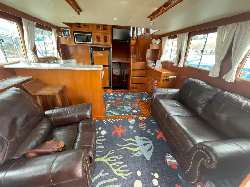 Slide: The Image of Luxurious interior of 2006 North Pacific 42 yacht with leather sofas and nautical-themed decor. - 6