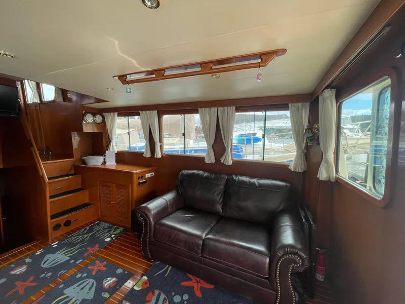 Slide: The Image of Interior of 2006 North Pacific 42 yacht with leather sofa and nautical decor. - 7