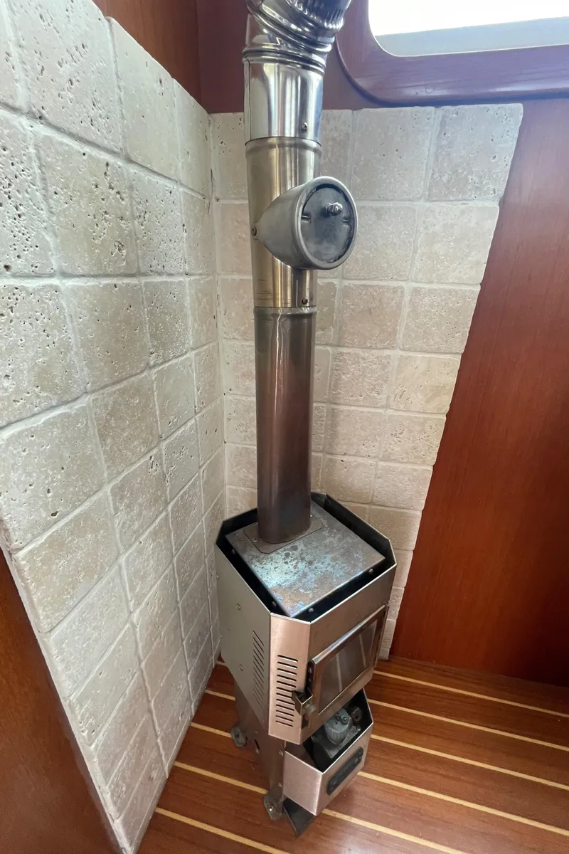 Slide: The Image of Wood stove in 2006 North Pacific 42 boat with tiled wall and wooden floor. - 9