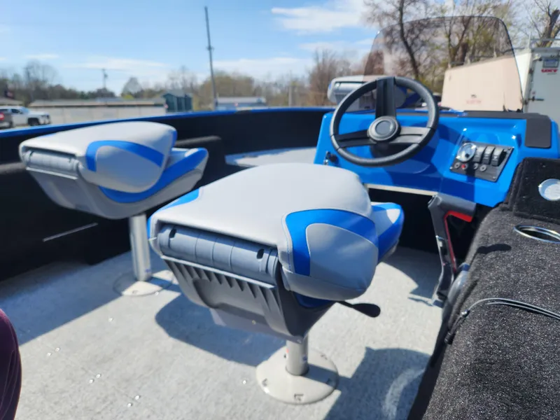 Slide: The Image of 2025 Smoker Craft Lazer 161 boat interior with blue and gray seating and steering console. - 10