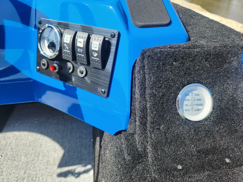 Slide: The Image of Control panel of 2025 Smoker Craft Lazer 161 boat with switches and indicators. - 12