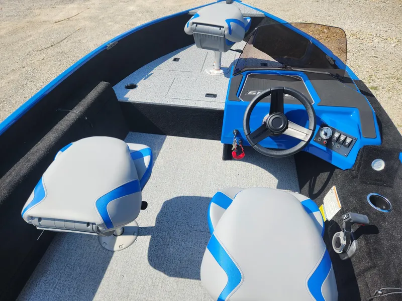 Slide: The Image of 2025 Smoker Craft Lazer 161 boat interior with blue and gray seating and steering console. - 13