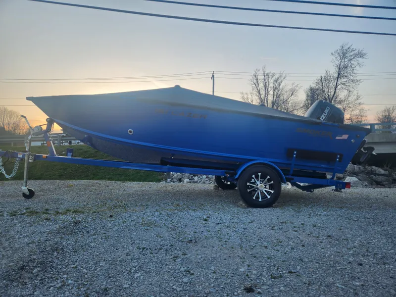 Slide: The Image of 2025 Smoker Craft Lazer 161 boat on trailer at sunset, side view. - 17