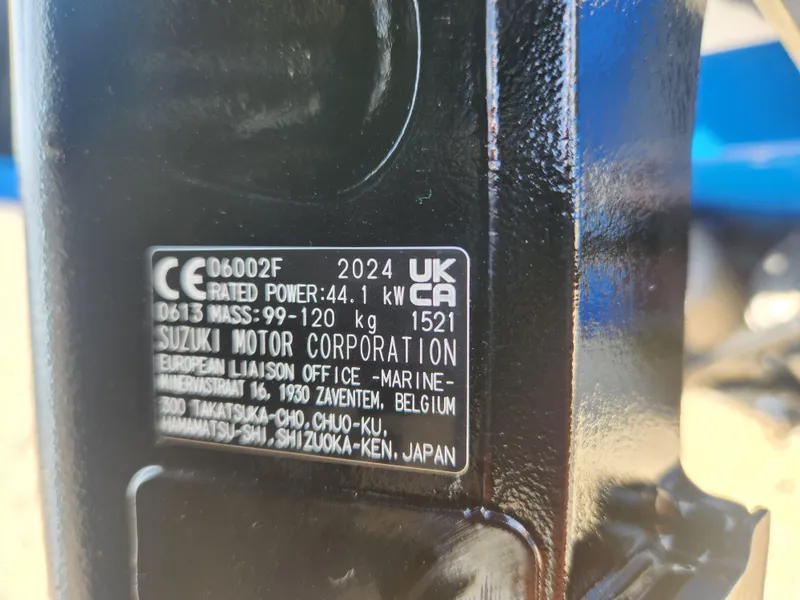 Slide: The Image of Close-up of Suzuki Motor Corporation label on 2025 Smoker Craft Lazer 161 boat engine. - 6