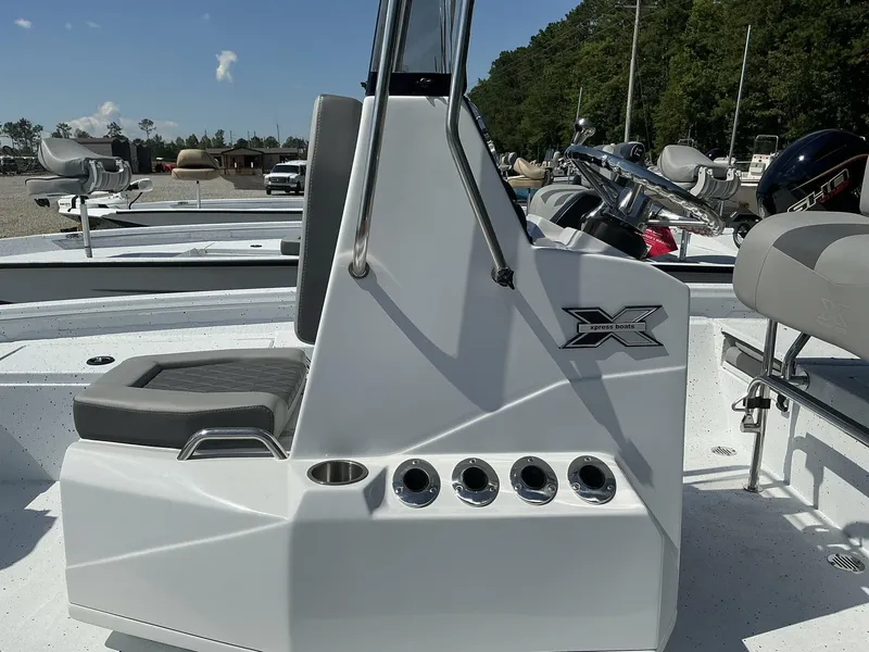 Slide: The Image of 2025 Xpress Hyper-Lift Series H20B boat console with seating, outdoors. - 4