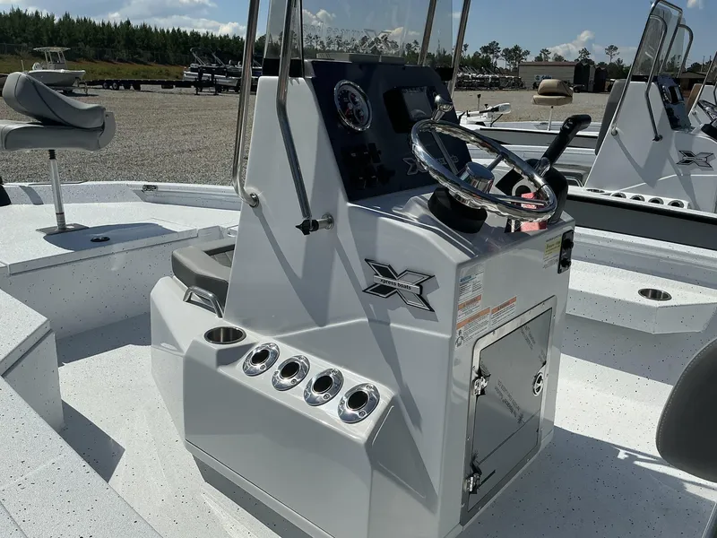 Slide: The Image of 2025 Xpress Hyper-Lift Series H20B boat console with steering wheel and seating. - 6