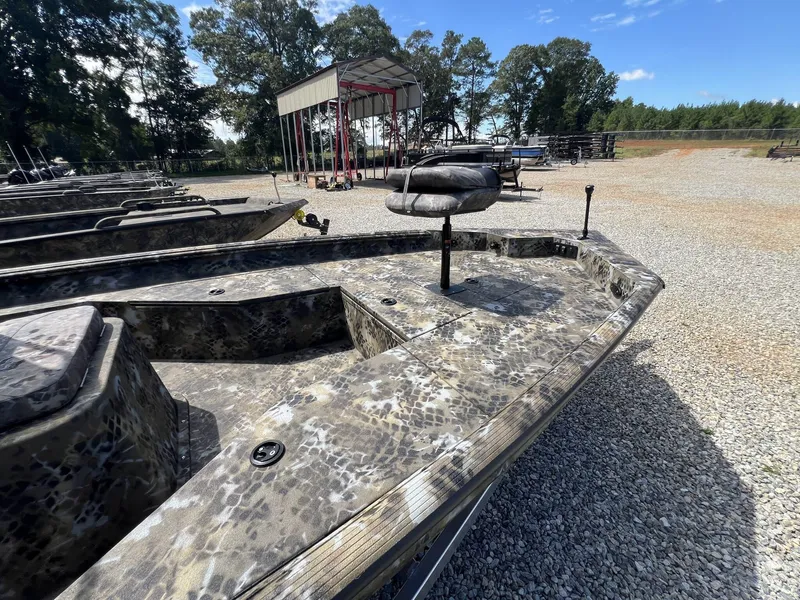 Slide: The Image of 2025 Excel Bay Pro 203 Elite boat with camouflage design in outdoor showroom. - 5