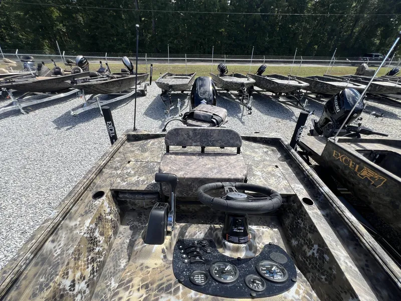 Slide: The Image of 2025 Excel Bay Pro 203 Elite boat with camo design, steering console, and multiple gauges. - 8