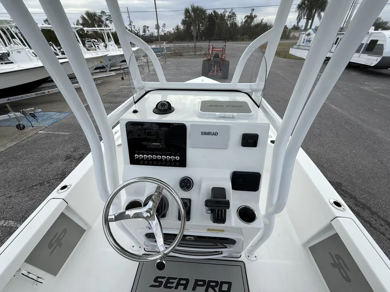 Slide: The Image of 2025 Sea Pro 230 Bay boat dashboard with steering wheel and controls. - 4