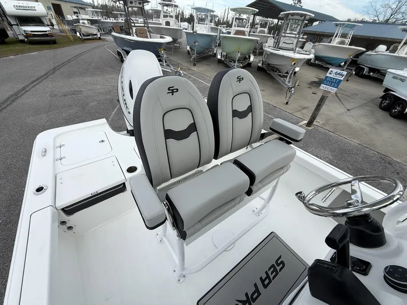 Slide: The Image of 2025 Sea Pro 230 Bay boat interior with dual seats and steering wheel. - 6