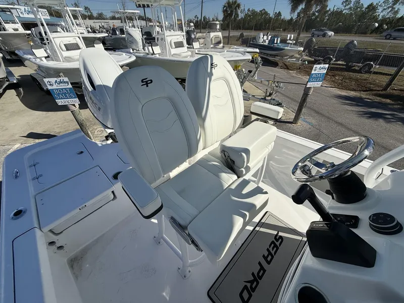 Slide: The Image of 2025 Sea Pro 230 Bay boat interior with steering wheel and seating. - 9