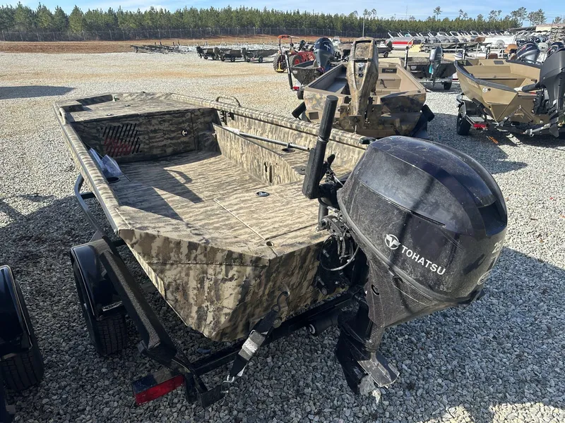 Slide: The Image of 2025 Excel Viper F4 1554 Eclipse Electric Trim boat with Tohatsu 25HP engine in a gravel lot. - 3