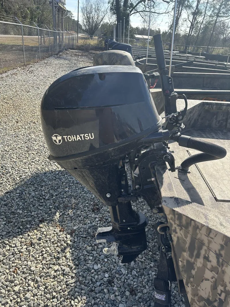 Slide: The Image of 2025 Excel Viper F4 1554 boat with Tohatsu outboard motor on gravel lot. - 4