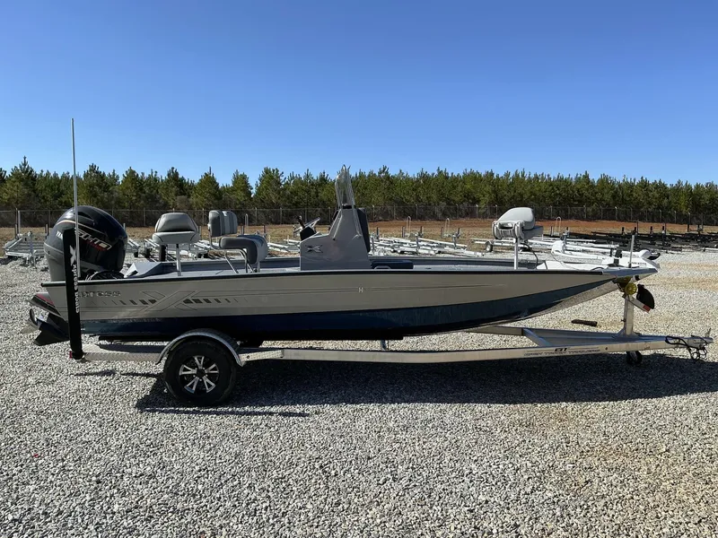 Slide: The Image of 2025 Xpress Hyper-Lift Series H20B boat with new console on gravel lot. - 1
