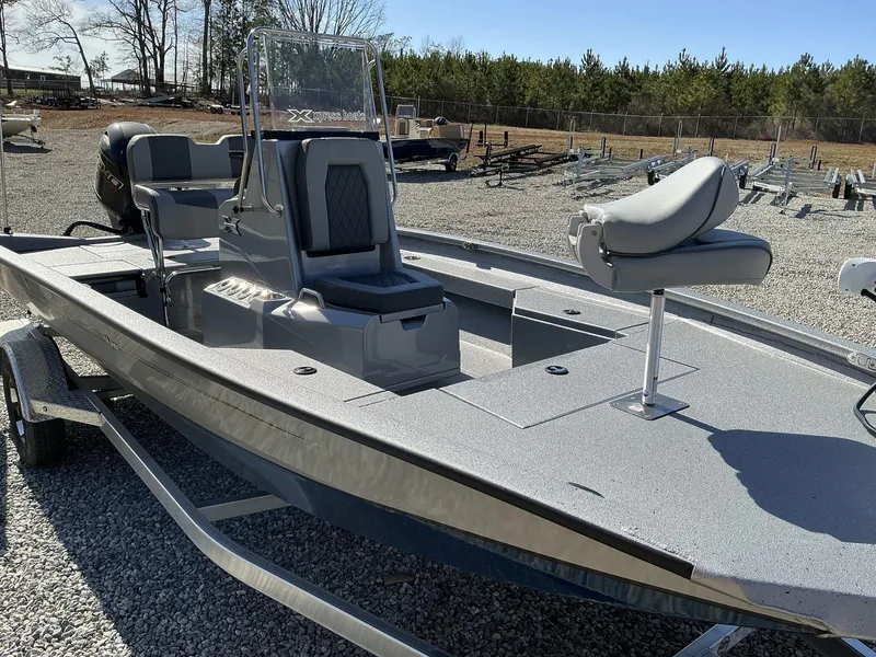 Slide: The Image of 2025 Xpress Hyper-Lift Series H20B boat with new console, parked on gravel. - 5