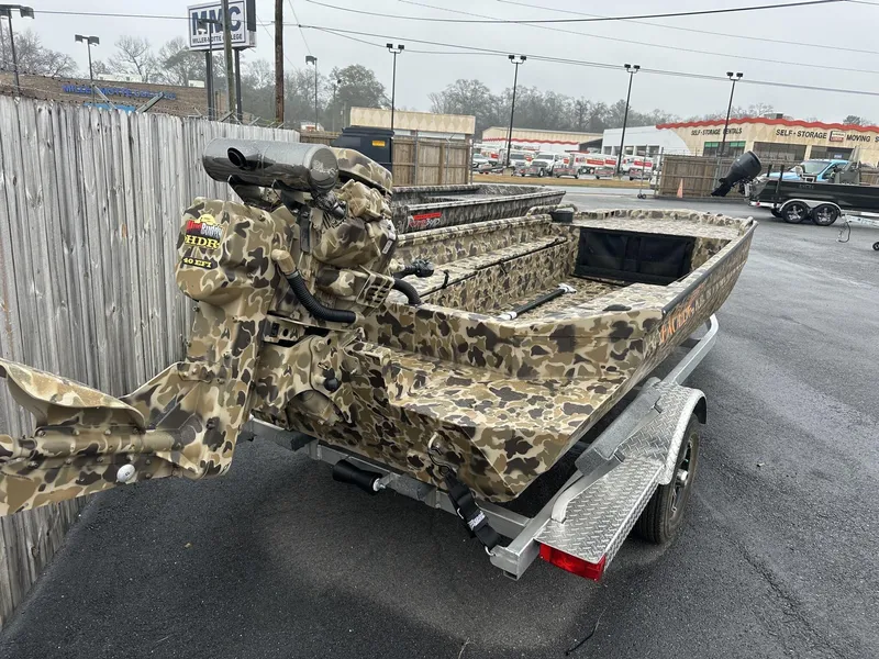 Slide: The Image of Camouflage-patterned Excel Shallow Water F4 boat on trailer, 2025 model, parked outdoors. - 3