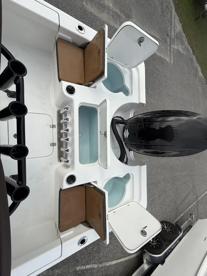 Slide: The Image of 2025 Sea Pro 230 Bay boat with open storage compartments and powerful outboard motor. - 6