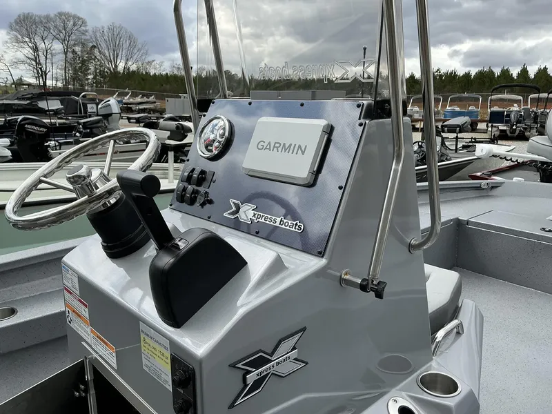 Slide: The Image of 2025 Xpress Hyper-Lift Series H22B boat console with Garmin system and steering wheel. - 4