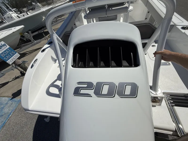 Slide: The Image of 2025 Sea Pro 225FLX SANDBAR boat with 200 horsepower engine, displayed at a marina. - 5
