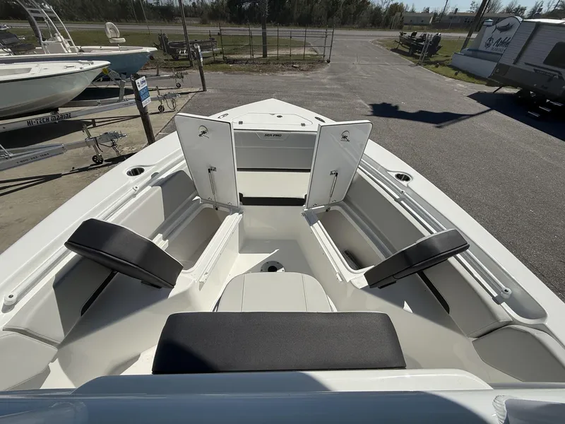 Slide: The Image of 2025 Sea Pro 225FLX SANDBAR boat interior with open storage compartments and seating. - 7